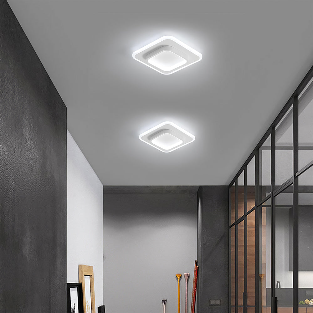 Modern ceiling lights in a room with gray walls and a staircase.