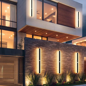 Modern building exterior with illuminated windows and decorative lights.