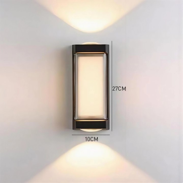 Wall-mounted outdoor light fixture with dimensions on a plain wall.